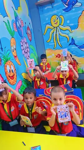 Children in our ocean-themed classroom holding up their artwork